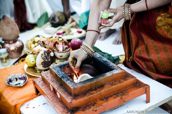 Bride lights fire beginning traditional Indian blessing.