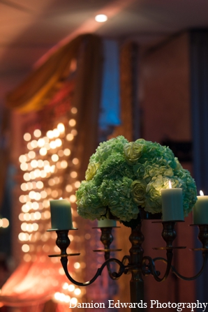 Emerald green floral arrangements topped tables at the sangeet.