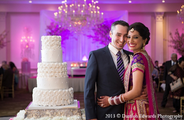 An Indian bride and groom choose a pink color palette for the decor of their wedding ceremony and reception. The bride dons colorful ensembles for both her ceremony and reception saris.