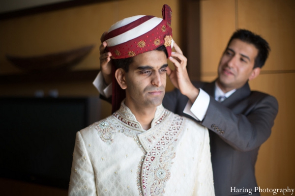 indian wedding groom getting dressed sherwani