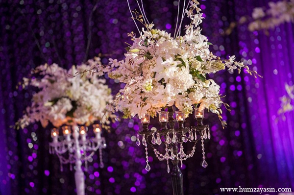 indian wedding reception white floral arrangments purple decor