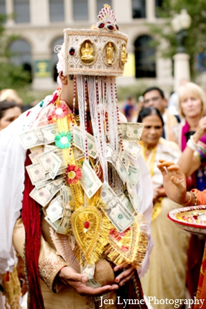 As part of the baraat ceremony, money is tucked into the Indian groom\'s outfit.