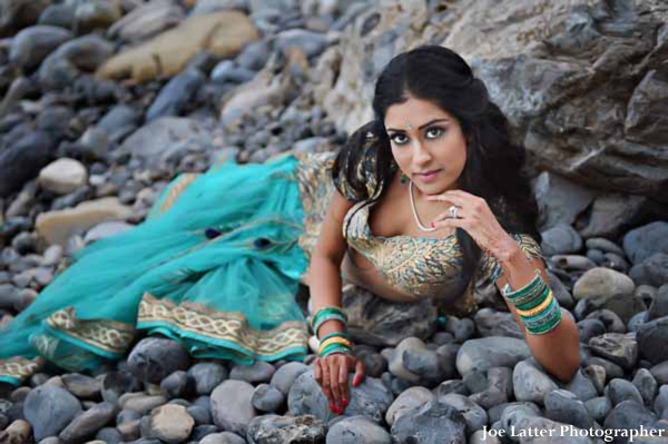 indian-wedding-bridal-portrait-lengha-laying-beach-rocks