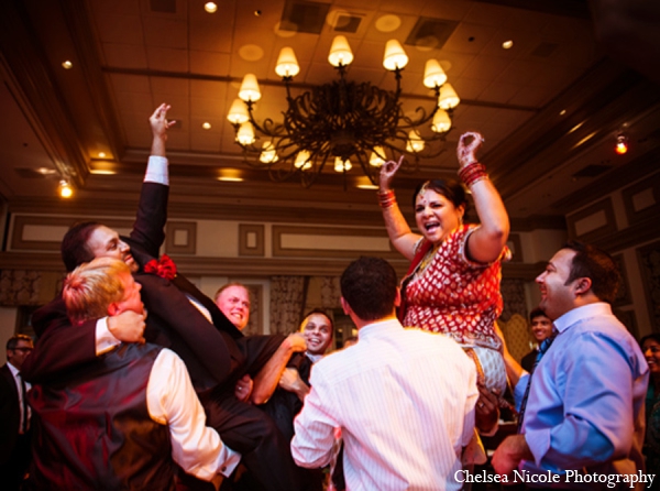 indian wedding reception red gold lighting celebrate