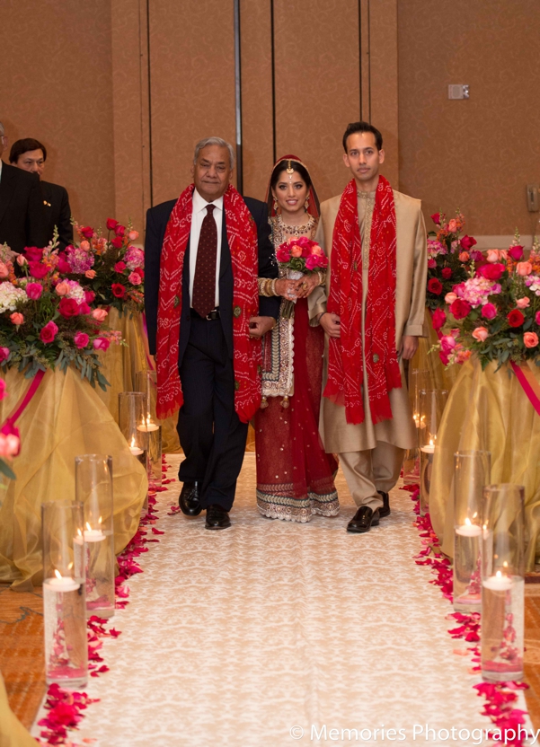 indian wedding bride walks down aisle