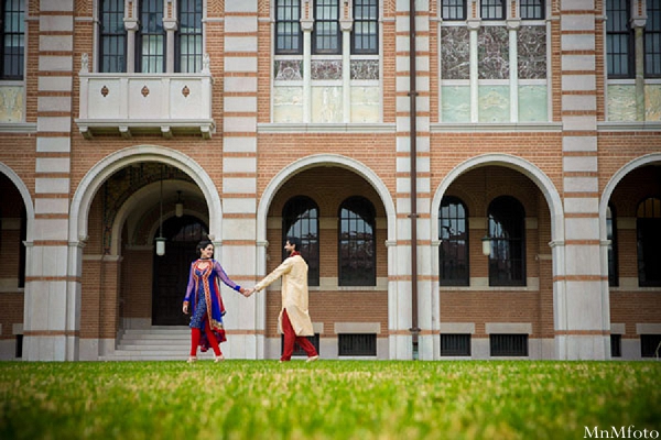 indian wedding bride and groom holding hands outside