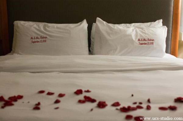 indian-wedding-couples-suits-rose-petals-bed