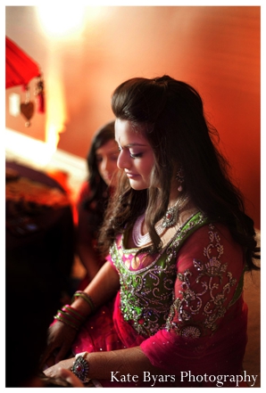 Indian bride wears pink and lime green bridal lengha at her mehndi party.