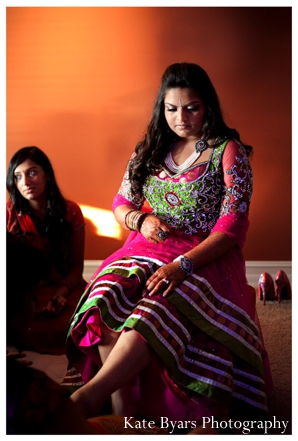 Indian bride receives bridal henna on her feet.