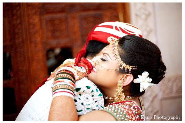 An indian bride and groom embrace before their indian wedding.