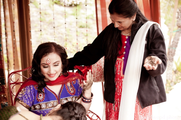 An Indian bride receives bridal mehndi.