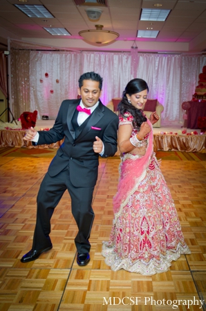 Indian bride and groom dance at their Indian wedding reception.