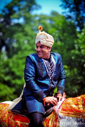 Indian groom rides into an Indian wedding baraat.