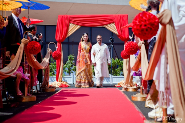 Indian bride wears bridal lengha at indian wedding ceremony.