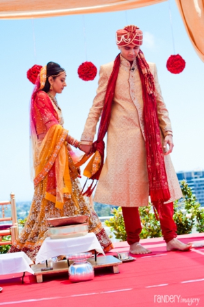 Indian bride and groom under indian wedding ceremony mandap