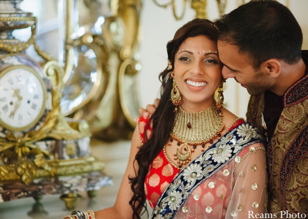 Indian bride wears bridal lengha and traditional bridal jewelry.