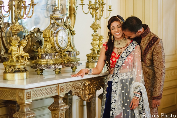 Indian bride wears pink and navy bridal lengha.