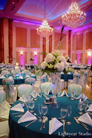 Teal blue and purple table setting at indian wedding reception.