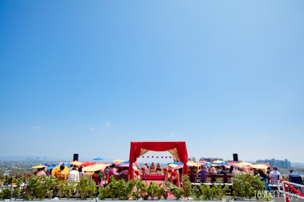 indian wedding ceremony under mandap overlooks city.