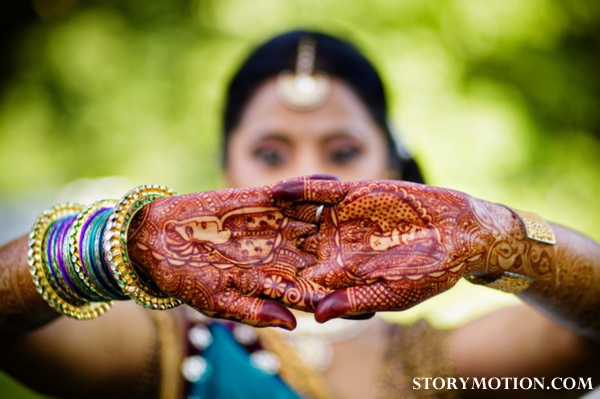 Indian bride wears bridal mehndi on her hands.