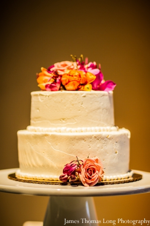 modern indian wedding cake with fresh flowers.