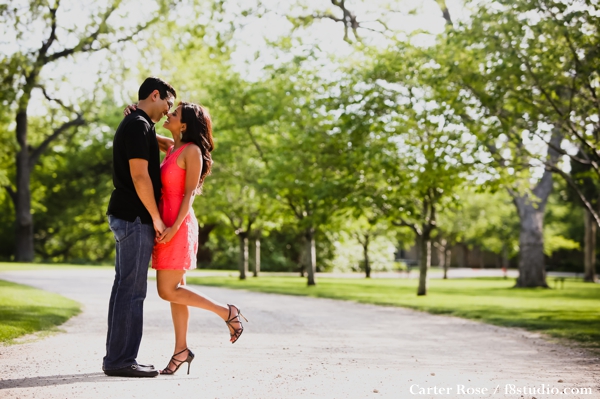 indian bride and groom take engagement photos in park.