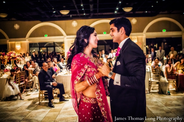 indian bride dances in her pink wedding lengha.