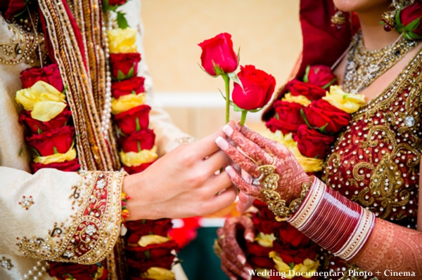 Indian bride wears red wedding lengha and traditional indian wedding jewelry.