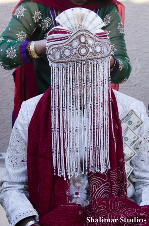 Indian groom wears traditional veil at indian wedding ceremony