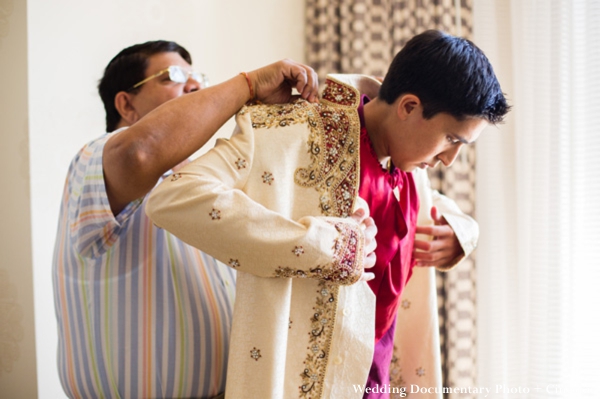 Indian groom puts on cream sherwani for indian wedding