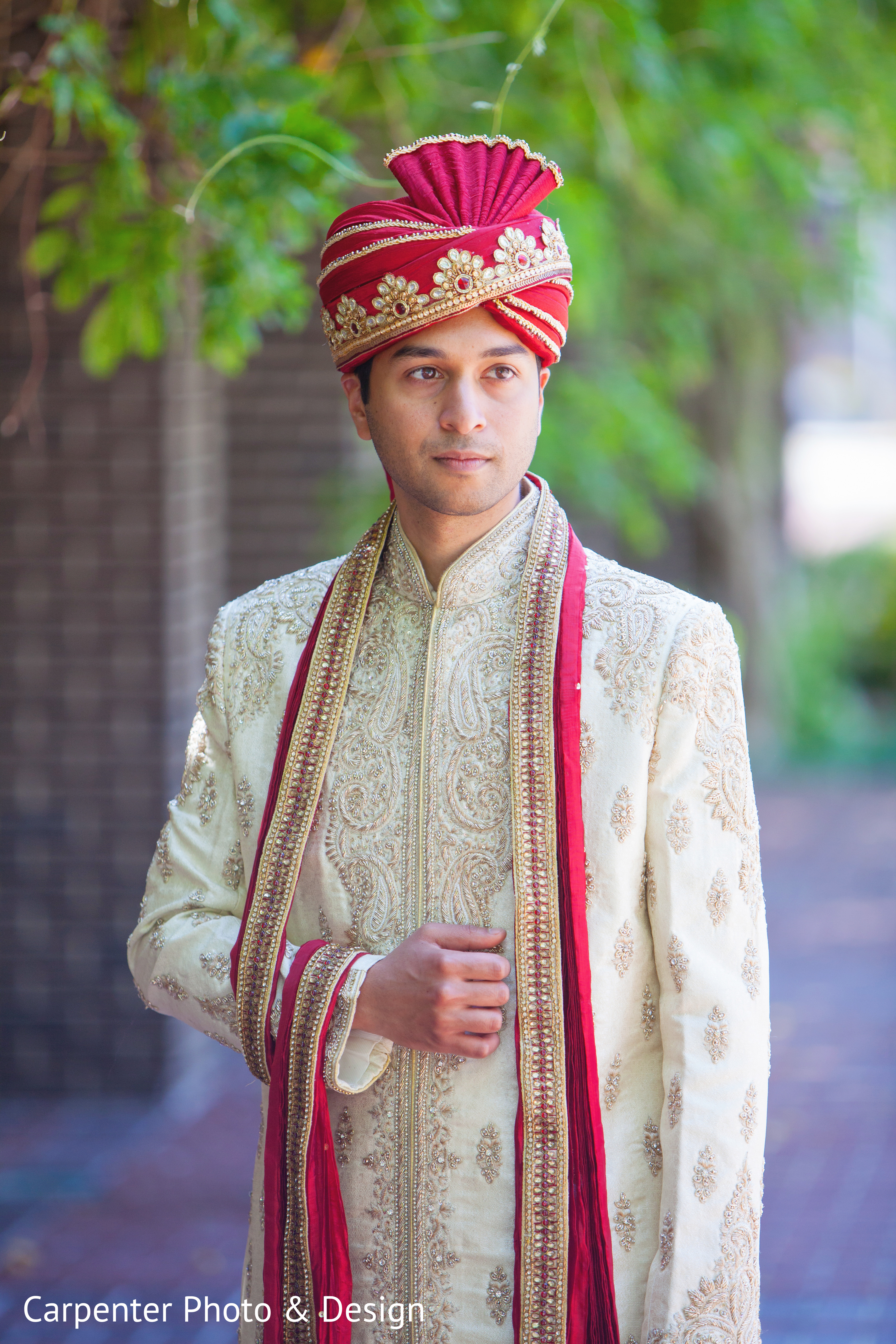 Young Indian Bride groom posing for photograph during their wedding. The  couple is wearing traditional indian wedding dress which is designer red  lehenga for bride and sherwani for groom Stock Photo |
