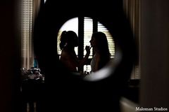 An Indian bride gets her hair and makeup done for her big day.