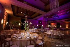 An Indian wedding reception that has a gold and white theme.