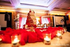 This beautiful Indian wedding reception features a classic gold and red color palette and our bride's ruby lengha is the perfect match!