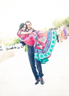 An Indian couple celebrate at their reception after their Tamil wedding ceremonies.