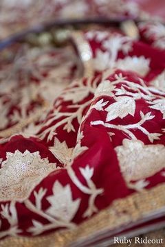 Pattern details on a red bridal lengha.