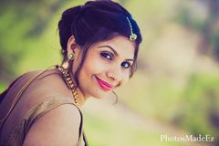 A bride has mehndi applied for her colorful sangeet party.