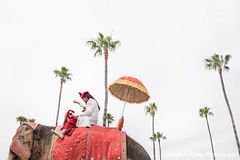 An Indian groom makes his way to the wedding venue on an elephant for the baraat.