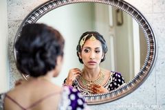 This beautiful Indian bride gets ready for her big wedding with some fabulous hair and makeup. Her multi-hued lengha choli is gorgeous!