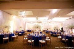 A Indian bride and groom go for a crisp peacock theme for their reception.