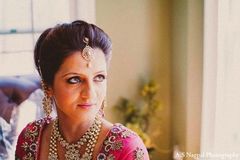 An Indian bride wears a hot pink Anarkali suit for her Punjabi ceremony.