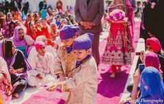 An Indian bride and groom wed in a vibrant hot pink Punjabi ceremony.