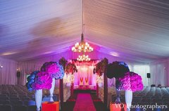 This traditional Indian wedding ceremony takes place under a gorgeous, sparkling mandap.