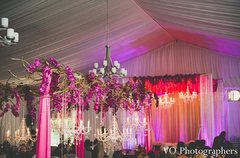 This Indian wedding reception is absolutely stunning in bright floral decor and twinkling chandeliers.