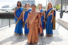 An Indian bride poses with her bridesmaids on her wedding day.