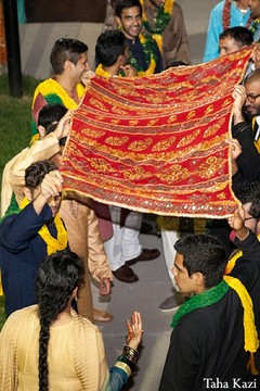 An Indian bride and groom celebrate at their mehndi night before their wedding ceremony.