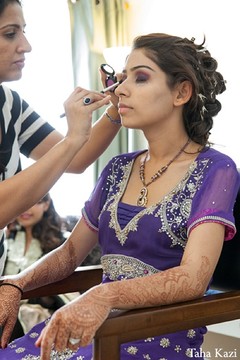 An Indian bride gets dolled up for her wedding reception.