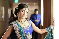 An Indian bride and groom take portraits at their wedding.