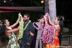 A bride and groom celebrate at their sangeet.