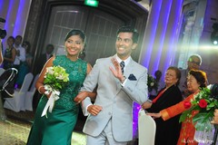 This Indian bride and groom look spectacular in bright teal-green and a sleek gray suit!